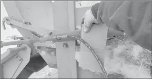  ?? (NDSU photo) ?? Pinhole leaks in hydraulic hose lines are extremely dangerous and can be impossible to see with the naked eye. Using a piece of cardboard to check for leaks protects hands and fingers.