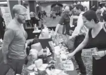  ??  ?? Attendees sample cheese at the Sheraton Denver Downtown.