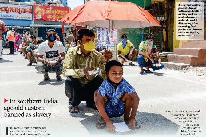  ?? Photo: AFP ?? A migrant worker protects his kid with an umbrella as they wait on marked areas to maintain social distancing after receiving food packets in Chennai, India, on April 1, 2020.