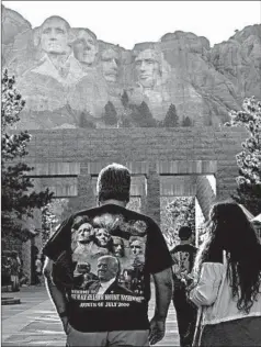  ?? ANDREW CABALLERO-REYNOLDS/AFP VIA GETTY IMAGES ?? Visitors walk to see the Mount Rushmore National Monument in Keystone, South Dakota, on Thursday.