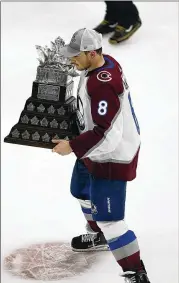  ?? JOHN BAZEMORE/ASSOCIATED PRESS ?? Colorado defenseman Cale Makar skates with the Conn Smythe Trophy, for being the playoffs MVP, after the Stanley Cup Finals clincher against the Lightning on Sunday night in Tampa, Fla.