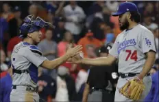  ??  ?? Los Angeles Dodgers relief pitcher Kenley Jansen shakes hands with catcher Austin Barnes after Game 4 of baseball’s World Series against the Houston Astros on Saturday in Houston. AP PHOTO/DAVID J. PHILLIP