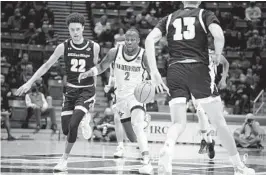  ?? DENIS POROY FOR THE U-T ?? San Diego State guard Adam Seiko drives downcourt last year vs. UC San Diego.