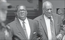  ?? Associated Press ?? Bill Cosby, right, leaves with his publicist Andrew Wyatt as poilce flank them Wednesday at the Allegheny County Courthouse after the third day of jury selection in Pittsburgh for his sexual assault case.