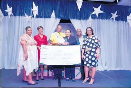  ??  ?? Carol Bourke (third from right), general manager, Hilton Rose Hall is thrilled to hand over a cheque and many other prizes to the Associate of the Year 2018, Devon East (third left). Sharing in the occasion are (from left) Kerrian Gardner, Associate of the Year 2017, Sagicor’s Wendy Bernard, Hilton’s John Miles and Nadine Reid.