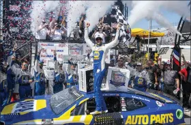  ?? JASON MINTO — THE ASSOCIATED PRESS ?? Chase Elliott, center, celebrates winning Monday’s NASCAR Cup Series race in Dover, Del.