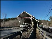  ?? LISA RATHKE — THE ASSOCIATED PRESS ?? A vehicle passes through the Miller’s Run covered bridge in Lyndon, Vt., on Tuesday, March 12, 2024. The historic bridge is under threat from truck drivers relying on GPS meant for cars continuall­y hitting the bridge.