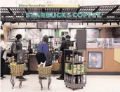  ?? James Nielsen / Houston Chronicle file ?? Customers line up at a Bush Interconti­nental Starbucks. The company says 1 in 6 American adults received its gift cards over the holidays.