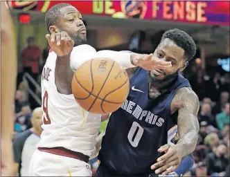  ?? [TONY DEJAK/THE ASSOCIATED PRESS] ?? Cleveland’s Dwyane Wade, left, knocks the ball away from Memphis’ JaMychal Green during Saturday’s game.