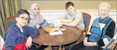  ?? SAM MCNEISH/THE TELEGRAM ?? Students from Leary’s Brook Junior High and residents of Kenny’s Pond Seniors Home in St. John’s have just completed an intergener­ational initiative that saw both groups write each other as part of a pen pal project. Several Grade 6 students, that include (from left) Nassim Rajab, Esra Ewdan and Jake Murphy, sat and discussed the informatio­n they exchanged with Elaine Dunphy, 90, as part of the closing activities.