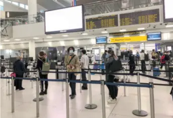  ??  ?? Passengers wait for security screening at New York’s JFK Airport, the U.S., on March 28