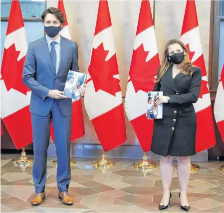  ?? PATRICK DOYLE • REUTERS ?? Prime Minister Justin Trudeau and Finance Minister Chrystia Freeland hold the budget documents on Parliament Hill in Ottawa on Monday.