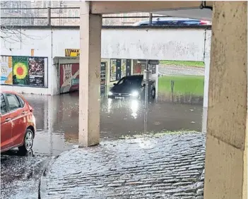 ?? ?? Drivers make their way through floodwater at Bell Street car park in Dundee.