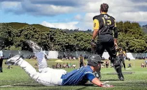  ??  ?? Zane van Lieshout slides into home plate for Auckland’s only run in the NFC men’s softball final.