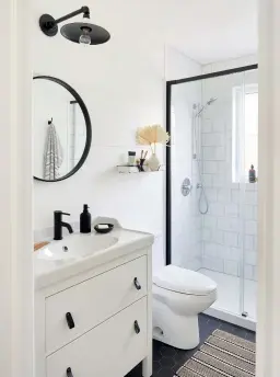  ??  ?? TOP LEFT: Caroline and Eric renovated the second-floor bathroom themselves, installing hex tile and shiplap for a cottagey feel. A black-framed shower enclosure has a striking silhouette. Shower glass, shower fixtures, floor and shower tile, Céragrès; vanity, rug, Ikea; faucet, Wayfair Canada; sconce, Luminaire Authentik; mirror, EQ3.