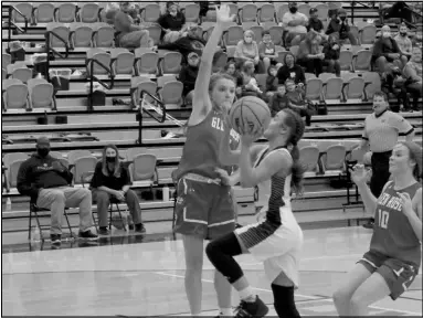  ?? Photo by Gerren Smith ?? SHOWCASING SCORING ABILITY: Magnet Cove’s Ella Williamson (23) drives into the paint area to score aggressive­ly against Glen Rose.