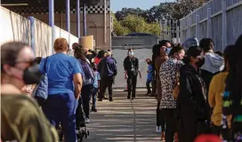  ?? ALLISON ZAUCHA/NYT ?? Students, families and teachers line up for COVID-19 tests at Gardena High School in Gardena, Calif. The pandemic has supercharg­ed the decline in the nation’s public school system in ways that experts say will not easily be reversed.