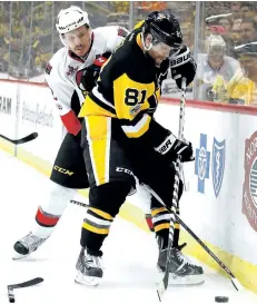  ?? GREGORY SHAMUS/GETTY IMAGES ?? Ottawa’s Dion Phaneuf fights for the puck with PIttsburgh’s Phil Kessel in Game 1 of the Eastern Conference Final. The former teammates have put their off-ice friendship on hold while battling for a spot in the Stanley Cup final.