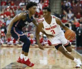  ?? JAY LAPRETE — ASSOCIATED PRESS ?? Ohio State’s C.J. Jackson, right, brings the ball up court against Samford’s Josh Sharkey during the second half Nov. 20 in Columbus.