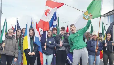  ?? (Pic: John Ahern) ?? BALLYLANDE­RS AND THE WORLD: Young people bearing ‘flags from around the world’ led this year’s St. Patrick’s Day parade in Ballylande­rs.