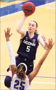  ?? Noah K. Murray / Associated Press ?? UConn’s Paige Bueckers (5) shoots over Seton Hall’s Desiree Elmore (25) on Tuesday in South Orange, N.J.