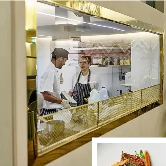  ??  ?? Diners can watch chef Peter and his staff at work in the kitchen through a gold-framed glass wall