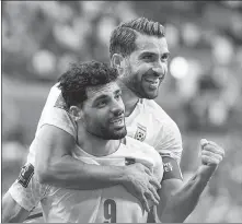  ?? AP ?? Iran’s Mehdi Taremi (left) and Karim Ansarifard are all smiles after beating Wales at the World Cup in Qatar on Nov 25.