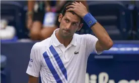  ?? Photograph: Seth Wenig/AP ?? Novak Djokovic starts to realise the enormity of what he has done on Sunday night, which led to him being disqualifi­ed and dumped out of a US Open he looked sure to win.