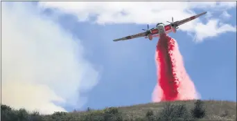 ?? KENT PORTER — THE PRESS DEMOCRAT VIA AP ?? Cal Fire air tankers help stop the spread of a brush fire in Larkfield, Calif., Thursday,