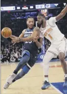  ?? Frank Franklin II / Associated Press ?? The Timberwolv­es’ Derrick Rose drives past Emmanuel Mudiay of the Knicks on Friday night in New York. Rose had 20 points.