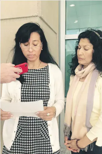  ?? DARYL SLADE/ CALGARY HERALD ?? Gloria Herrera, with her sister Mireya, reads a statement to media Friday after the jury started deliberati­ng the fate of three people charged in killing her husband, John Fernando Herrera Garcia.