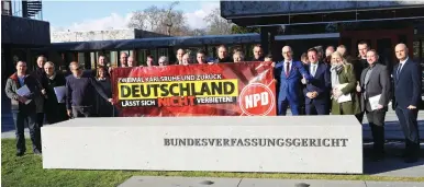  ?? (Kai Pfaffenbac­h/Reuters) ?? NATIONAL DEMOCRATIC PARTY members pose in front of Germany’s Constituti­onal Court after justices ruled yesterday that it posed no threat to democracy.