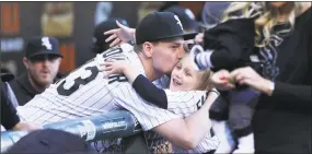  ?? Chris Sweda / TNS ?? White Sox pitcher Danny Farquhar has some fun with his family before throwing out the ceremonial first pitch before a game last season.