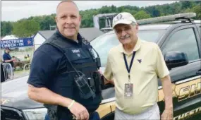  ??  ?? Chester County Deputy Sheriff Matthew ‘Jamie’ Mendenhall is shown with Doug Paisley, the father of county music superstar Brad Paisley.