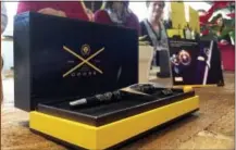  ?? THE ASSOCIATED PRESS ?? A pen that the A.T. Cross Co. says is made partly from melted-down assault rifles is on display as employees watch an opening ceremony for a new flagship A.T. Cross Co. store Wednesday in Providence, R.I. The 170-year-old pen maker says sales of the...