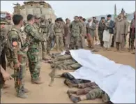  ?? (AFP) ?? Afgan security forces gather around the bodies of Taliban militants killed in Khogyani district of Nangarhar province on Friday.