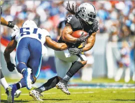  ?? WESLEY HITT — GETTY IMAGES ARCHIVES ?? In his Raiders debut, Marshawn Lynch runs past Tennessee Titans’ linebacker Avery Williamson during last week’s season-opening win.