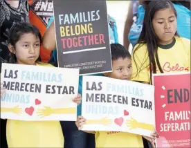  ?? WILFREDO LEE/THE Associated Press ?? Children hold signs during a demonstrat­ion in front of the Immigratio­n and Customs Enforcemen­t offices in Miramar, Fla. The Trump administra­tion’s move to separate immigrant parents from their children on the U.S.-Mexico border has turned into a...