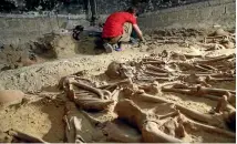  ??  ?? An archaeolog­ist works on a mass grave for bubonic plague victims from the Middle Ages found in Paris.