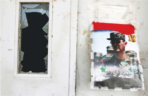  ?? (Reuters) ?? A POSTER of Syrian regime leader Bashar Assad in Latakia.