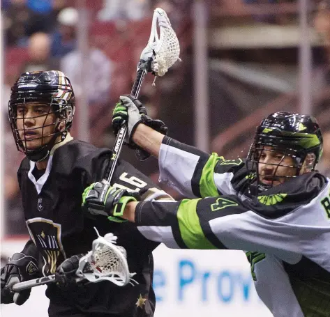  ?? GERRY KAHRMANN ?? The Warriors’ Mitch Jones, left, is pushed by the Rush’s Kyle Rubisch at Rogers Arena in Vancouver in a game Jan. 12. The Rush next face the Calgary Roughnecks on Saturday, after losing two games in a row to Georgia and Toronto.