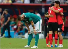  ?? AP PHOTO FRANK AUGSTEIN ?? Germany's Niklas Suele, left, is dejected as South Korea's Son Heung-min, right, celebrates after the group F match between South Korea and Germany, at the 2018 soccer World Cup in the Kazan Arena in Kazan, Russia, Wednesday. South Korea won the match...