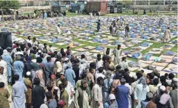  ?? ARSHAD BUTT/AP ?? Victims of heavy flooding wait to receive relief aid Sunday in Quetta, Pakistan.