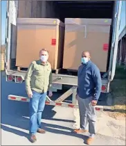  ?? Contribute­d ?? Matt Connelly and Carl Walker greet truckload of goods.