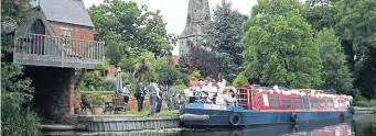  ?? PHOTOS SUPPLIED ?? The wedding party and decorated boat moored alongside St James’ Church, Normanton-on-Soar.