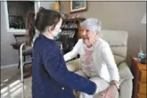  ?? (AP Photo/Steven Senne) ?? Eileen Quinn, 98, right, a resident at New Pond Village retirement community in Walpole, Mass., greets great-granddaugh­ter Maeve Whitcomb, 6, on Sunday. Quinn said it was the first time she has visited with Maeve in her apartment since the pandemic began.