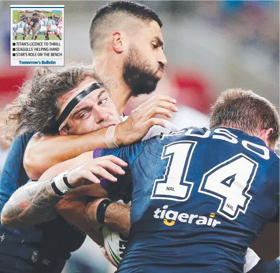  ?? Picture: GETTY IMAGES ?? Cowboy Ethan Lowe gets a bit of love from Storm defenders during last night’s game at AAMI Park.