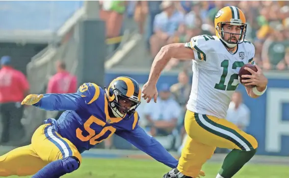  ?? JIM MATTHEWS/USA TODAY NETWORK-WIS ?? Packers quarterbac­k Aaron Rodgers (12) scrambles against the Rams on Sunday.