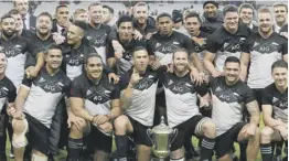  ??  ?? 2 New Zealand celebrate their win over France with the Gallaher Trophy, which is competed for by the two teams in memory of Dave Gallaher, the captain of the ‘Original All Blacks’ who died in the First World War.