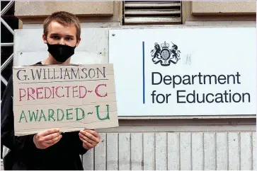  ??  ?? DOWNGRADED: A student protests about the Education Minister amid the A-level estimates